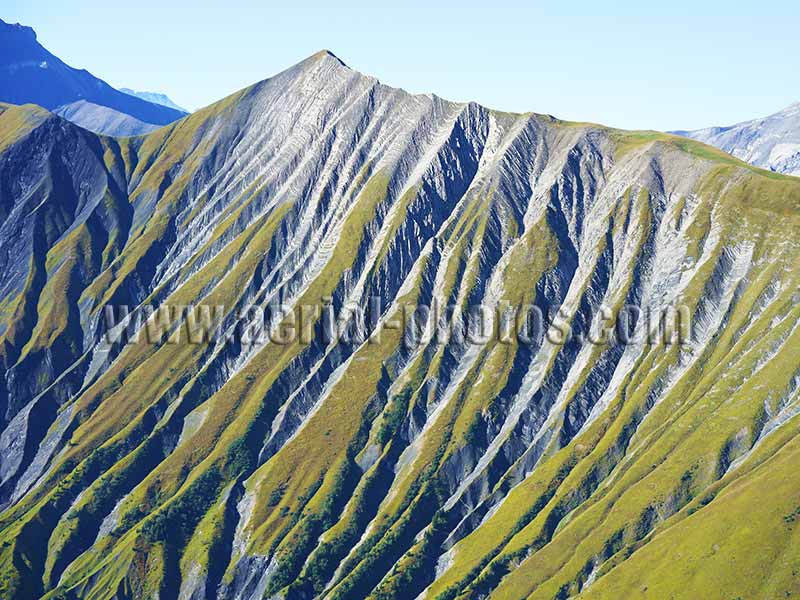 Aerial view. Photo of a steep grassy slope with ravines, Savoie, Auvergne-Rhône-Alpes, France. Vue aérienne.