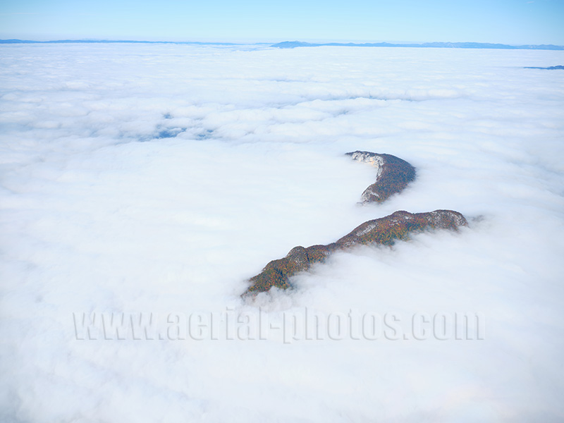 Aerial view. Photo of Mont Veyrier above a sea of clouds. Near Lake Annecy, Auvergne-Rhône-Alpes, France. Vue aérienne.