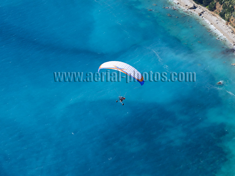 Aerial view of a paramotor flying above the Mediterranean on the Côte d'Azur in France. Vue aérienne.