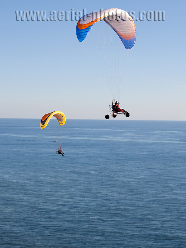 Aerial view of two paramotorists flying above the Mediterranean Sea of the French Riviera. Vue aérienne.