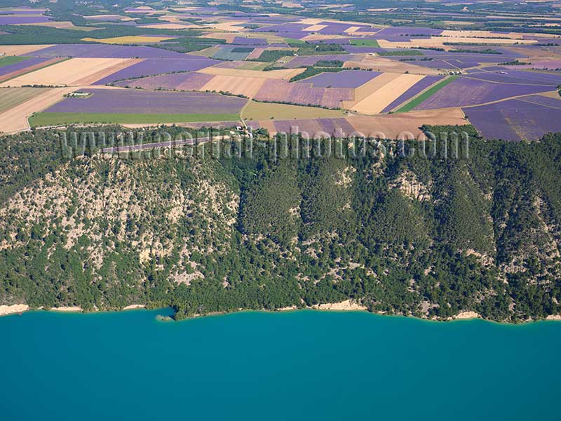 Aerial view of lavender fields on the Valensole Plateau overlooking Lake Sainte-Croix in Provence, France. Vue aérienne.