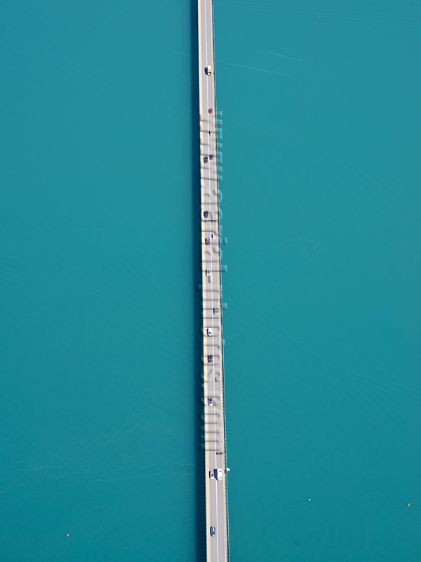 Aerial view of a bridge crossing Lake Serre-Ponçon in the Alps, France. Vue aérienne.