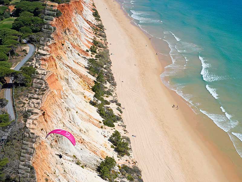 AERIAL VIEW photo of a paraglider, Falésia Beach, Albufeira, Algarve, Portugal. VISTA AEREA parapente, Praia da Falésia.