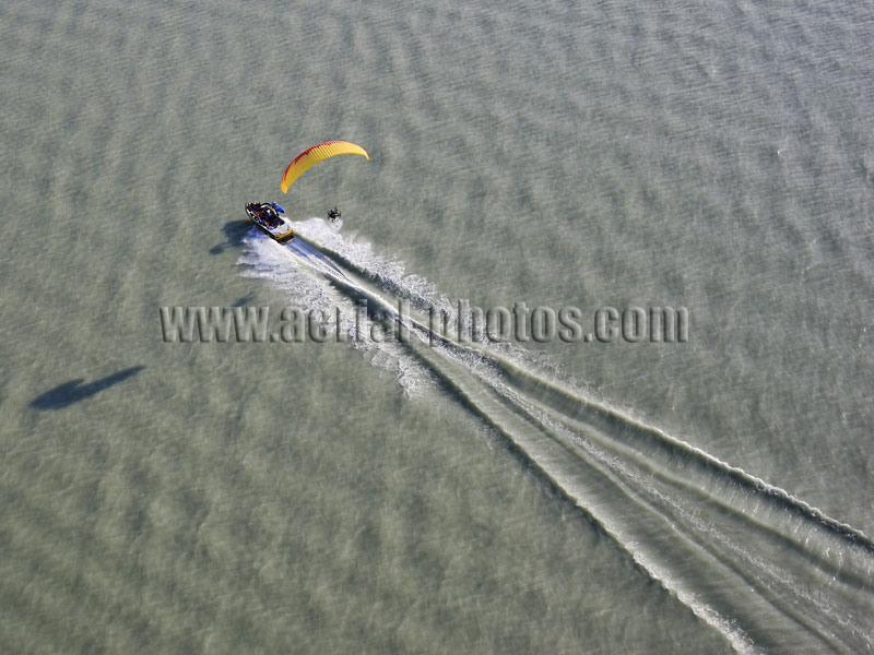 AERIAL VIEW photo of a paramotor following a boat, Utah Lake, Utah, United States.