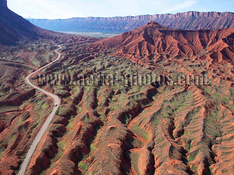 Aerial view of a winding road in red badlands, Castle Valley, Utah, USA.
